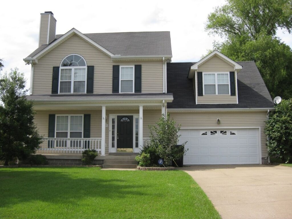 Traditional suburban two story house with garage and front porch
