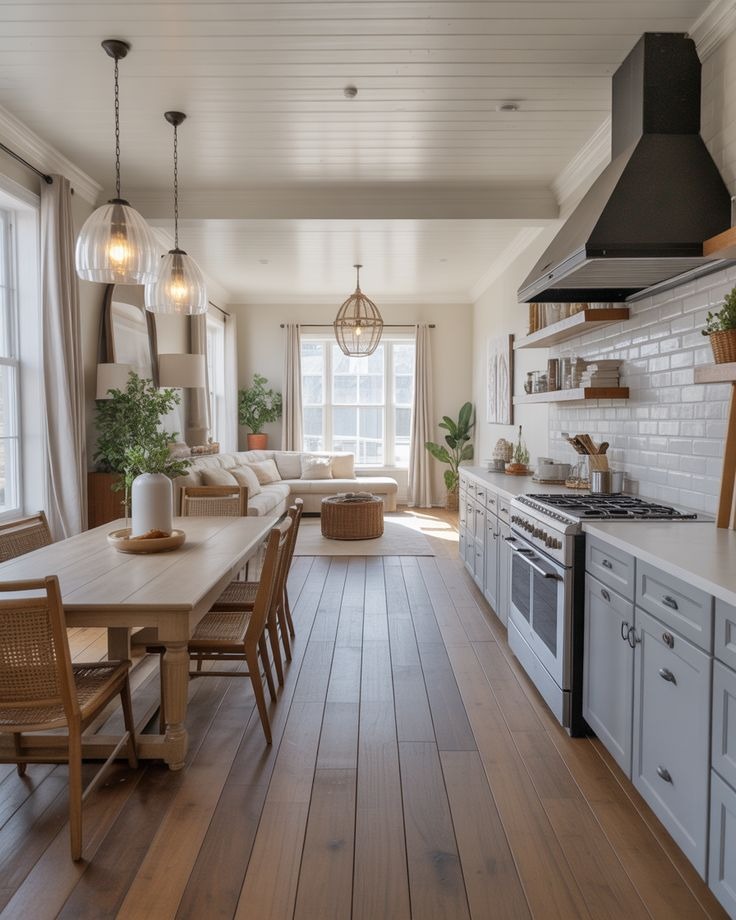 Bright open concept kitchen and living room with wood floors