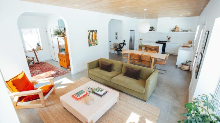 Bright open-concept living room with modern furniture and wood ceiling