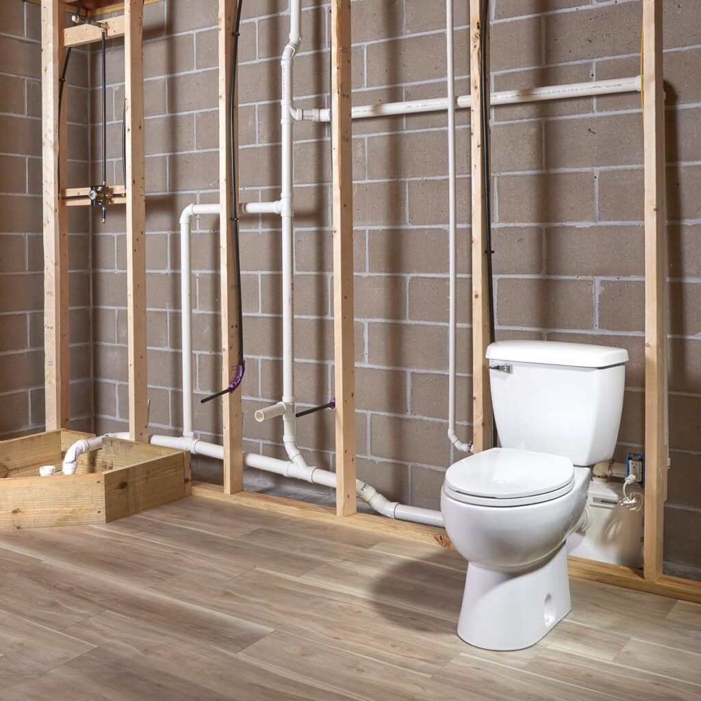 Basement bathroom rough-in showing toilet installation and plumbing lines