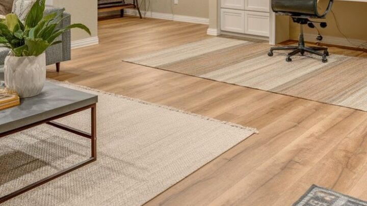 Modern finished basement with home office and warm wood flooring